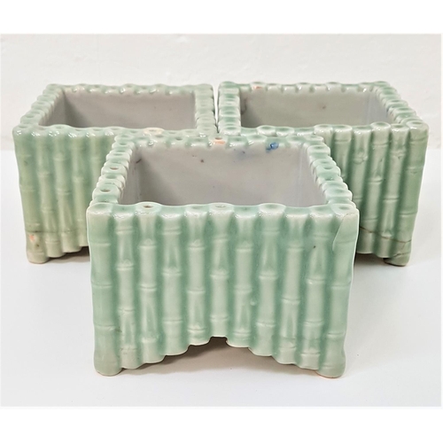 155 - THREE CHINESE PORCELAIN SQUARE PLANTERS
decorated as square bamboo planters, the interiors painted w... 