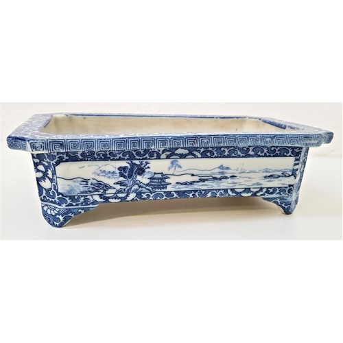 156 - CHINESE PORCELAIN OBLONG PLANTER
with canted corners and decorated with blue and white panels depict... 