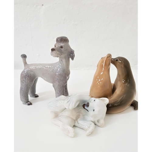 185 - THREE ROYAL COPENHAGEN ANIMAL ORNAMENTS
comprising a poodle numbered B 86, 14cm high; a polar bear c... 