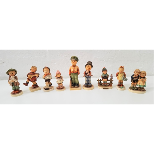 189 - NINE GOEBEL HUMMEL FIGURES
including a boy sitting on a fence, a girl with watering can, a boy holdi... 