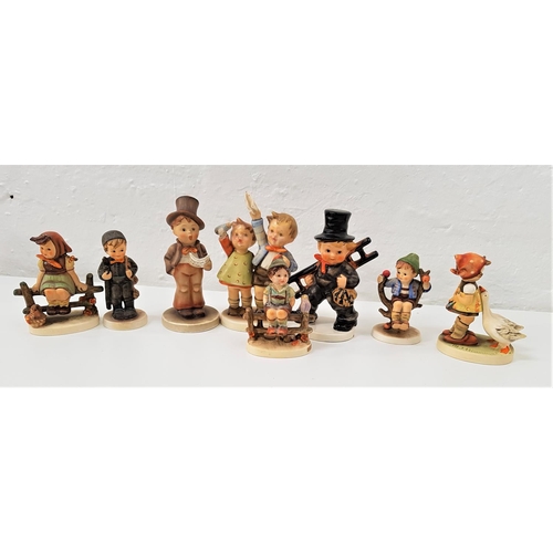 191 - EIGHT GOEBEL HUMMEL FIGURES
including a boy and a girl sitting on fences, a boy in top hat singing a... 