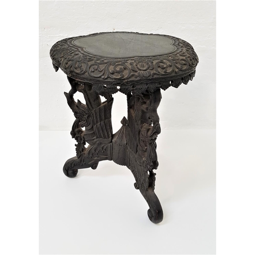 645 - CHINESE EBONISED OCCASIONAL TABLE
with a circular shaped carved top on three carved and pierced drag... 