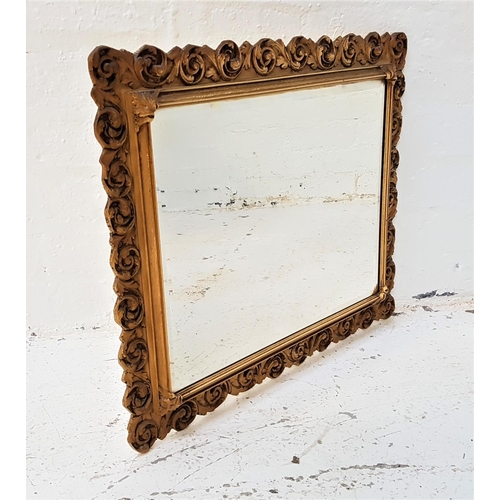 595 - DECORATIVE WALL MIRROR
with an oblong bevelled plate and an oak leaf scroll resin frame, 63cm wide