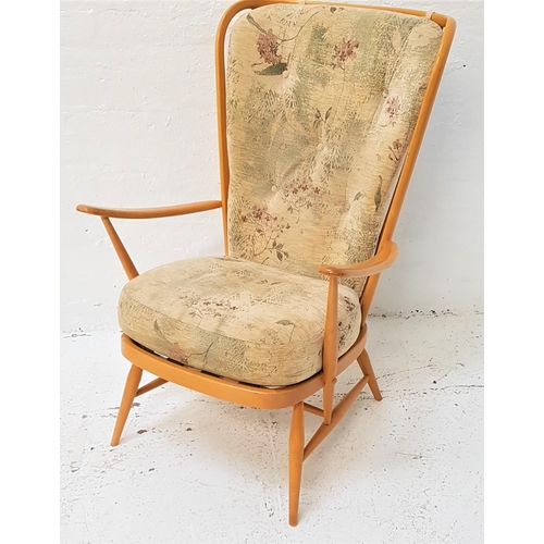 658 - ERCOL BEECH ARMCHAIR
with a shaped stick back with a loose button back cushion above a padded seat, ... 