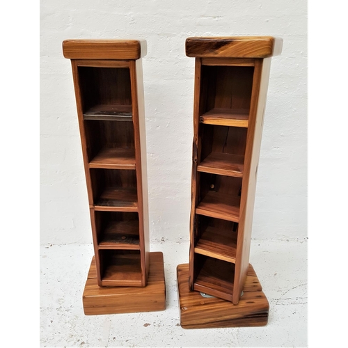 570 - PAIR OF TEAK ROTATING CD/DVD STORAGE TOWERS
each with five shelves, on a square base, 109cm high (2)