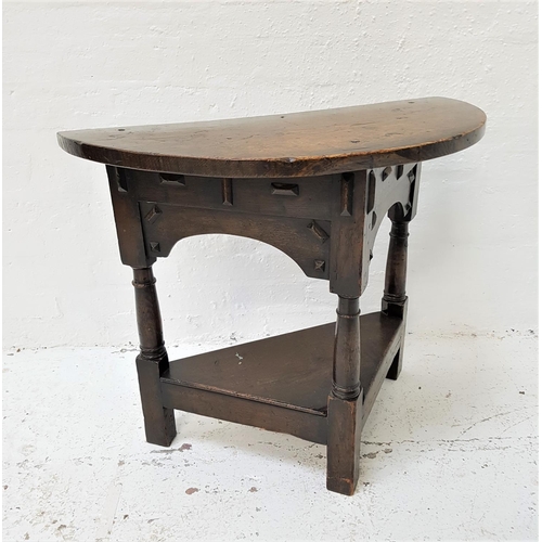 574 - OAK CREDENCE TABLE
with a D shaped top above an arched frieze, standing on three turned supports uni... 