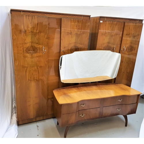 584 - BEAUTILITY WALNUT BEDROOM SUITE
comprising a shaped mirror back dressing table with a breakfront bas... 