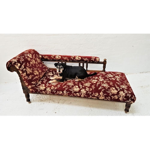 603 - EDWARDIAN MAHOGANY CHAISE LONGUE
with a scroll arm gallery rail, standing on turned supports with la... 