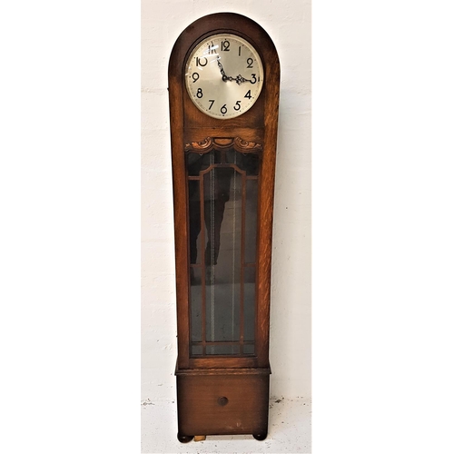 653 - 1930s OAK LONGCASE CLOCK
with a circular silvered dial with Arabic numerals and a 30 hour movement, ... 