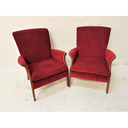 580 - PAIR OF PARKER KNOLL ARMCHAIRS
each with shaped padded backs, arms and seats, standing on shaped sup... 