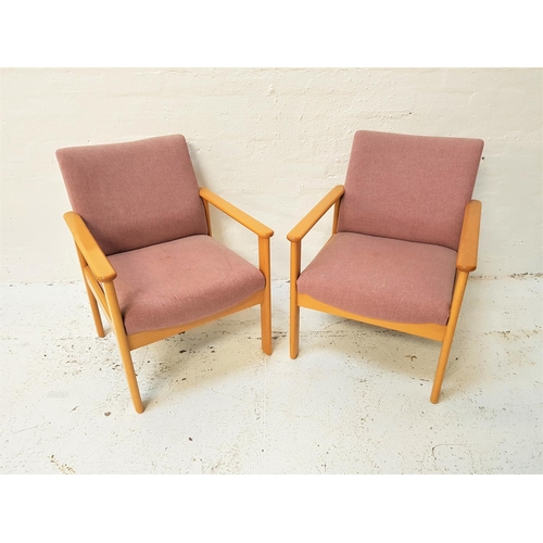 581 - PAIR OF BEECH FRAME ARMCHAIRS
with padded backs and seats, standing on shaped supports (2)