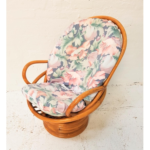 586 - CANED CONSERVATORY TYPE ARMCHAIR
on a circular swivel base with shaped loose back and seat cushions