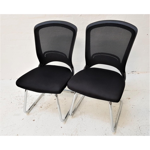 630 - PAIR OF OFFICE CHAIRS
with shaped mesh fabric backs above black fabric padded seats, standing on a t... 