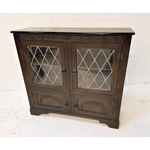 651 - STAINED OAK SIDE CABINET
with a carved decorative frieze above a pair of leaded glass doors, above a... 