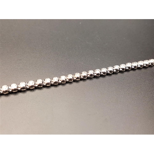 66 - IMPRESSIVE DIAMOND LINE BRACELET
the bezel set diamonds totaling approximately 2cts, in nine carat w... 