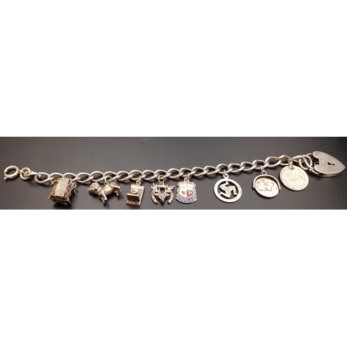 126 - SILVER CHARM BRACELET
the curb link bracelet with heart padlock clasp and a variety of charms includ... 