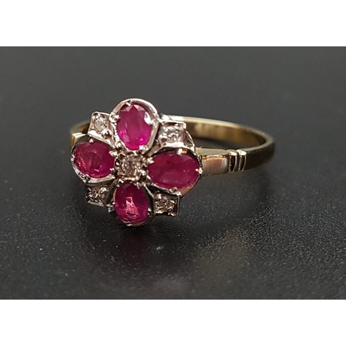 104 - RUBY AND DIAMOND CLUSTER RING
the four oval cut rubies separated by small diamonds and with a furthe... 