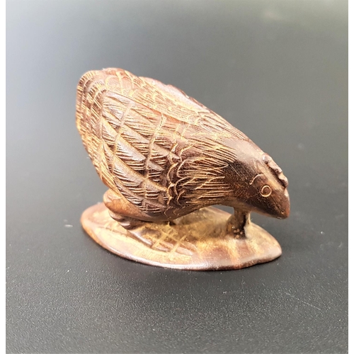 63 - JAPANESE HARDWOOD NETSUKE
depicting a chicken eating a worm from the earth, signed to base, 4.4cm lo... 