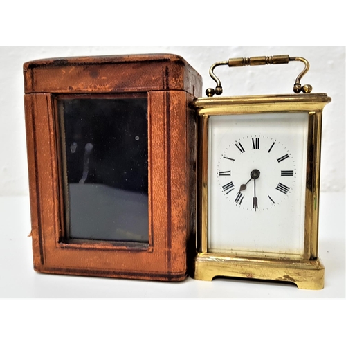 294 - GILT BRASS CARRIAGE CLOCK
the enamelled dial with Roman numerals and a French movement, with a fold ... 