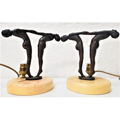 296 - PAIR OF ART DECO STYLE LAMPS
raised on painted marble effect circular bases with a male and female n... 