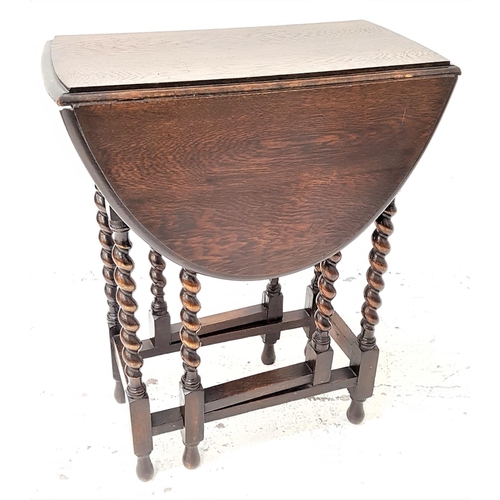 462 - OAK GATE LEG OCCASIONAL TABLE
with shaped drop flaps, standing on barley twist supports, 59.5cm wide