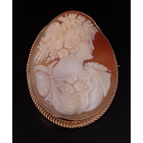 104 - LARGE SHELL CAMEO BROOCH
depicting a female in profile with elaborate hairstyle decorated with flowe... 