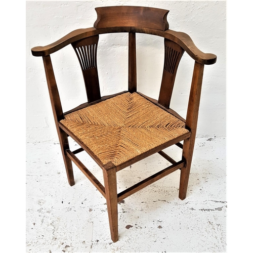 523 - WALNUT CORNER CHAIR
with a shaped top rail and arms above two pierced splats and a square woven seat... 