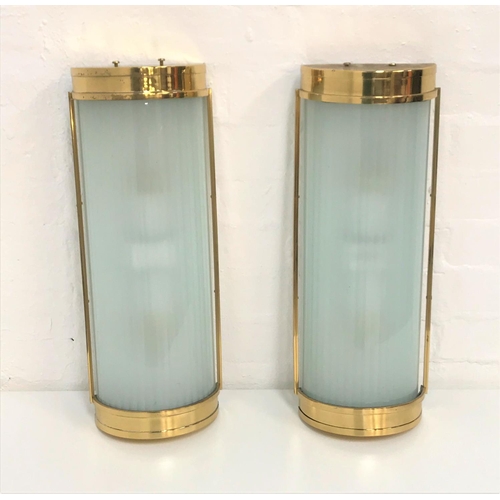 492 - TWO DOMED WALL LIGHTS
with brass frames and opaque ribbed glass shades, 50cm long (2)