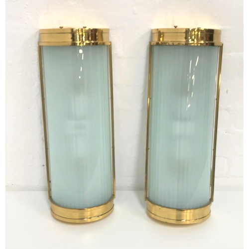 494 - TWO DOMED WALL LIGHTS
with brass frames and opaque glass shades, 50cm long