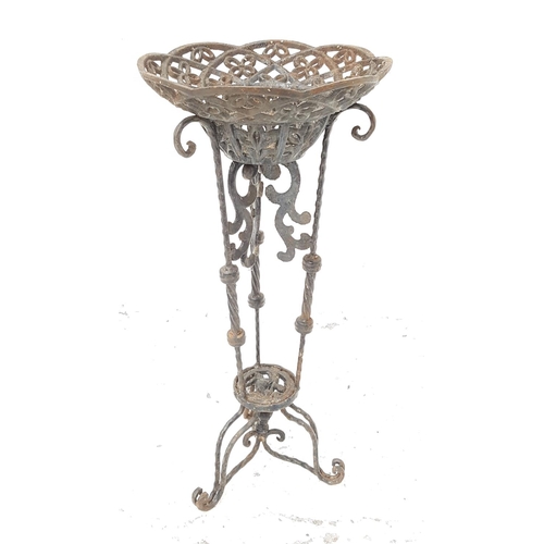 307 - EDWARDIAN METAL JARDINERE STAND
with a pierced dished top on three shaped columns with three scroll ... 