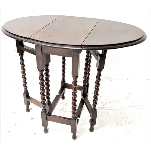 462 - OAK GATE LEG OCCASIONAL TABLE
with shaped drop flaps, standing on barley twist supports, 59.5cm wide