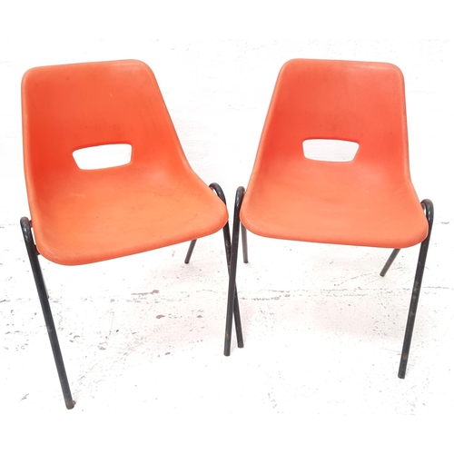 486 - PAIR OF STACKING CHAIRS
with orange plastic one piece bodies on black tubular metal frame supports (... 