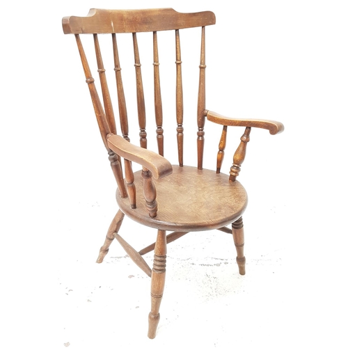 512 - 19th CENTURY OAK OPEN ARM CHAIR
with a shaped top rail above a turned column back and scroll arms, w... 