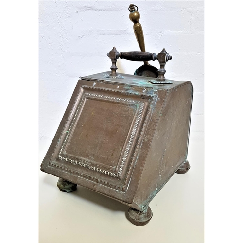 305 - BRASS COAL SCUTTLE
with a turned wood carry handle above a sloping front panelled lid opening to rev... 