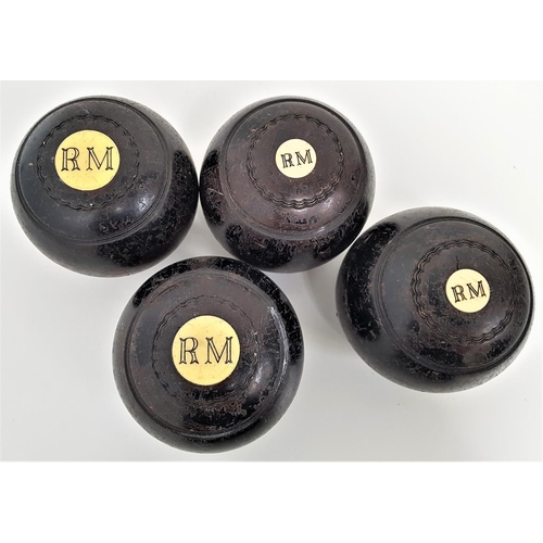 354 - SET OF FOUR LAWN BOWLS
in lignum vitae with ivorine disks marked RM (4)