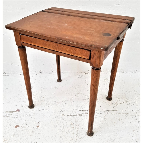 490 - VINTAGE ELM CHILD'S SCHOOL DESK
with a pen trough and lift up lid above a front flap, standing on ta... 