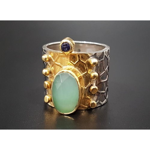 163 - UNUSUAL FLUORITE AND KYANITE DRESS RING
the wide silver band with textured detail and gilt decorated... 