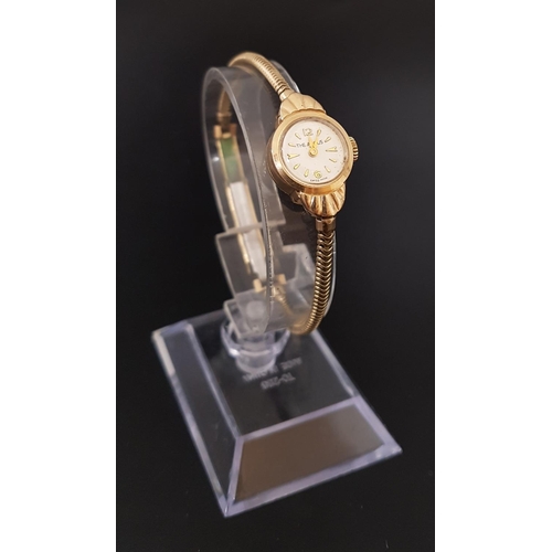 116 - LADIES NINE CARAT GOLD CASED 'THE ANGUS' WRISTWATCH
the dial with Arabic 6 and 12, and baton five mi... 