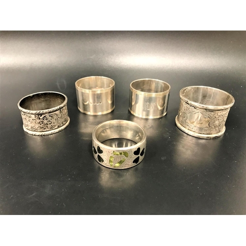 178 - FIVE VARIOUS SILVER NAPKIN RINGS
comprising a pair of plain design with monograms JW and NW, by Garr... 