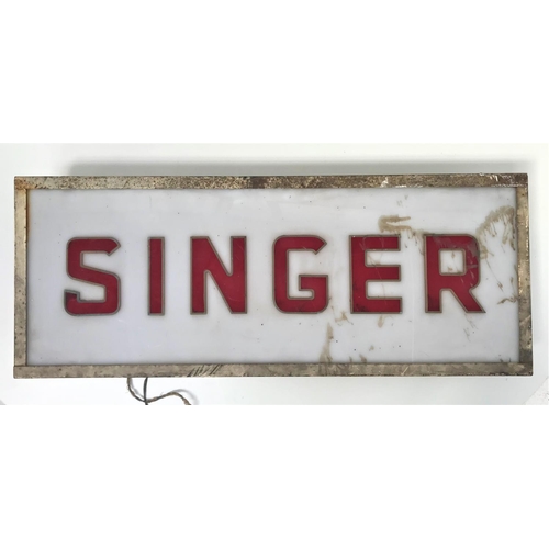 309 - 1950'S SINGER ILLUMINATED SHOWROOM SIGN
with an opaque plastic backing with red lettering, in a meta... 