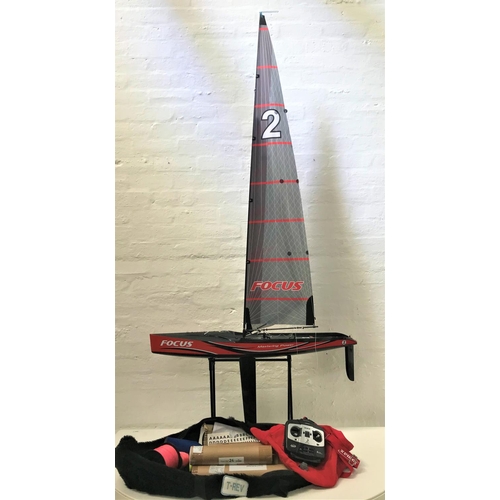 391 - LARGE RADIO CONTROLLED POND YACHT
the hull and sail marked 'Focus', with operating instructions, spa... 