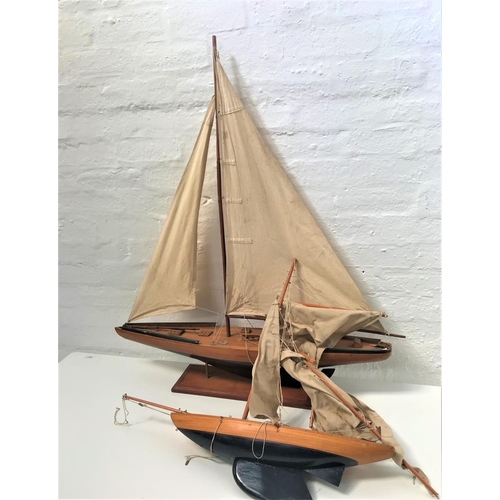 392 - 20th CENTURY MAHOGANY MODEL YACHT
with a painted dark blue hull, full rigging and mounted on a stand... 