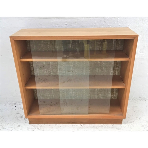 466 - LIGHT TEAK BOOKCASE
with a rectangular top now applied with a light oak transfer, above a pair of gl... 