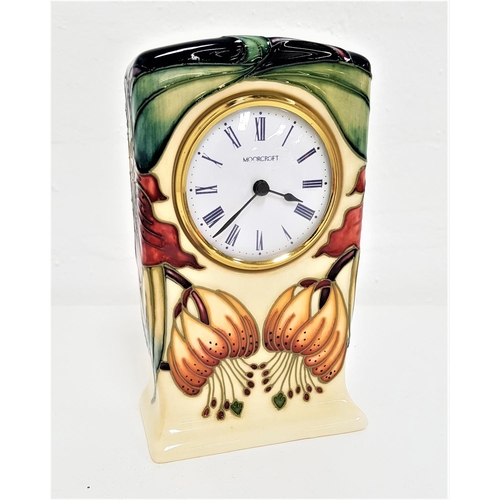 184 - MOORCROFT 'ANNA LILY' PATTERN MANTEL CLOCK
the tube lined floral decoration on a cream ground, 16cm ... 