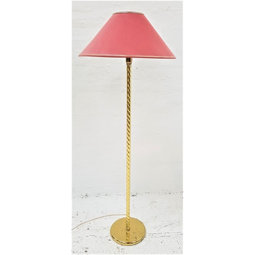 588 - BRASS STANDARD LAMP
raised on a circular base with a spiral effect column and pink shade, 139cm high