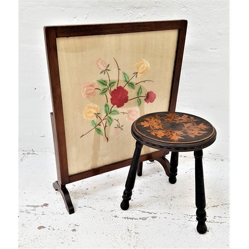 589 - COMBINATION FIRE SCREEN/OCCASIONAL TABLE
with an embroided floral panel under glass, standing on spl... 