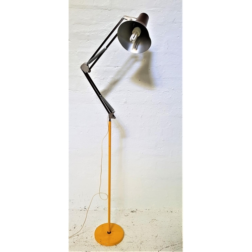 587 - FLOOR STANDING ANGLE POISE LAMP
raised on a circular yellow metal base with a tubular column and two... 