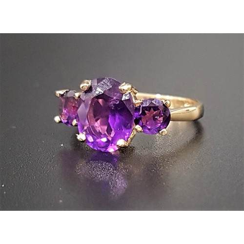 114 - GRADUATED AMETHYST THREE STONE RING
the large central oval cut amethyst approximately 2.2cts, flanke... 