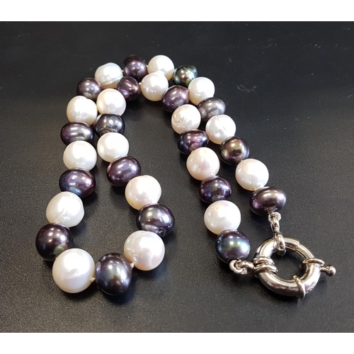 74 - BLACK AND WHITE FRESHWATER PEARL NECKLACE
with alternating black and white pearls, all individually ... 