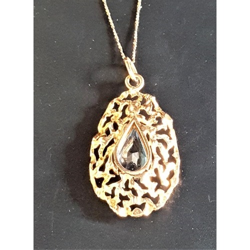 85 - ATTRACTIVE NINE CARAT GOLD PENDANT
the pierced and shaped pendant with central faceted blue glass, o... 